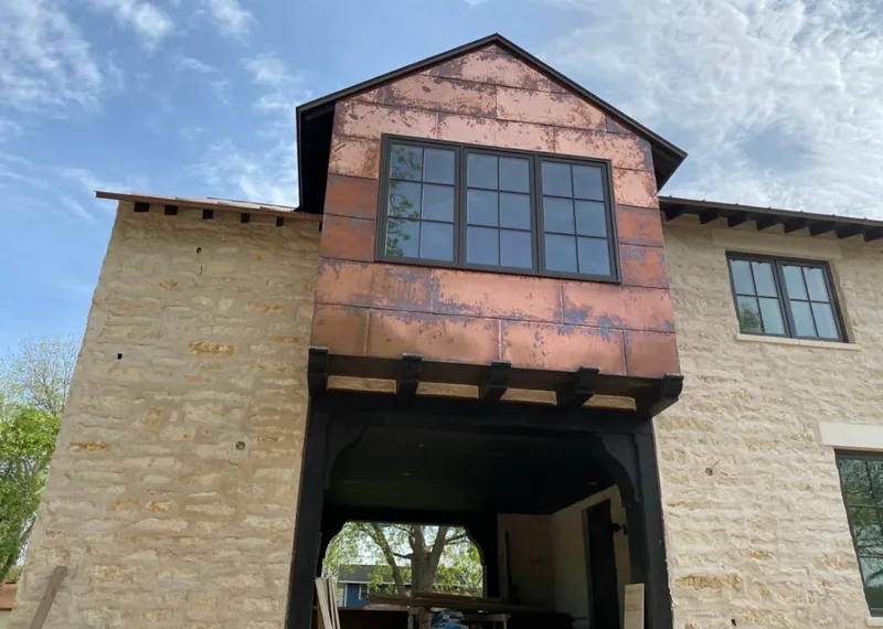 Copper metal panel facade on a stone building for Skylight Installation in Bradley